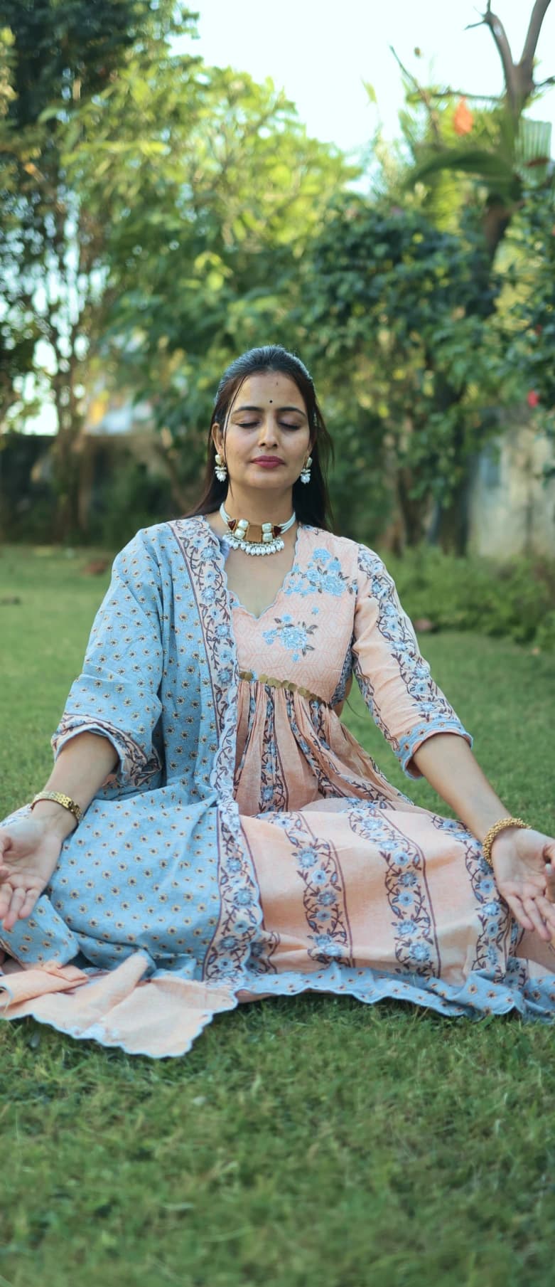 Person meditating in forest